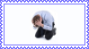 stock image of a guy on his knees with his hands on his head, clearly distressed